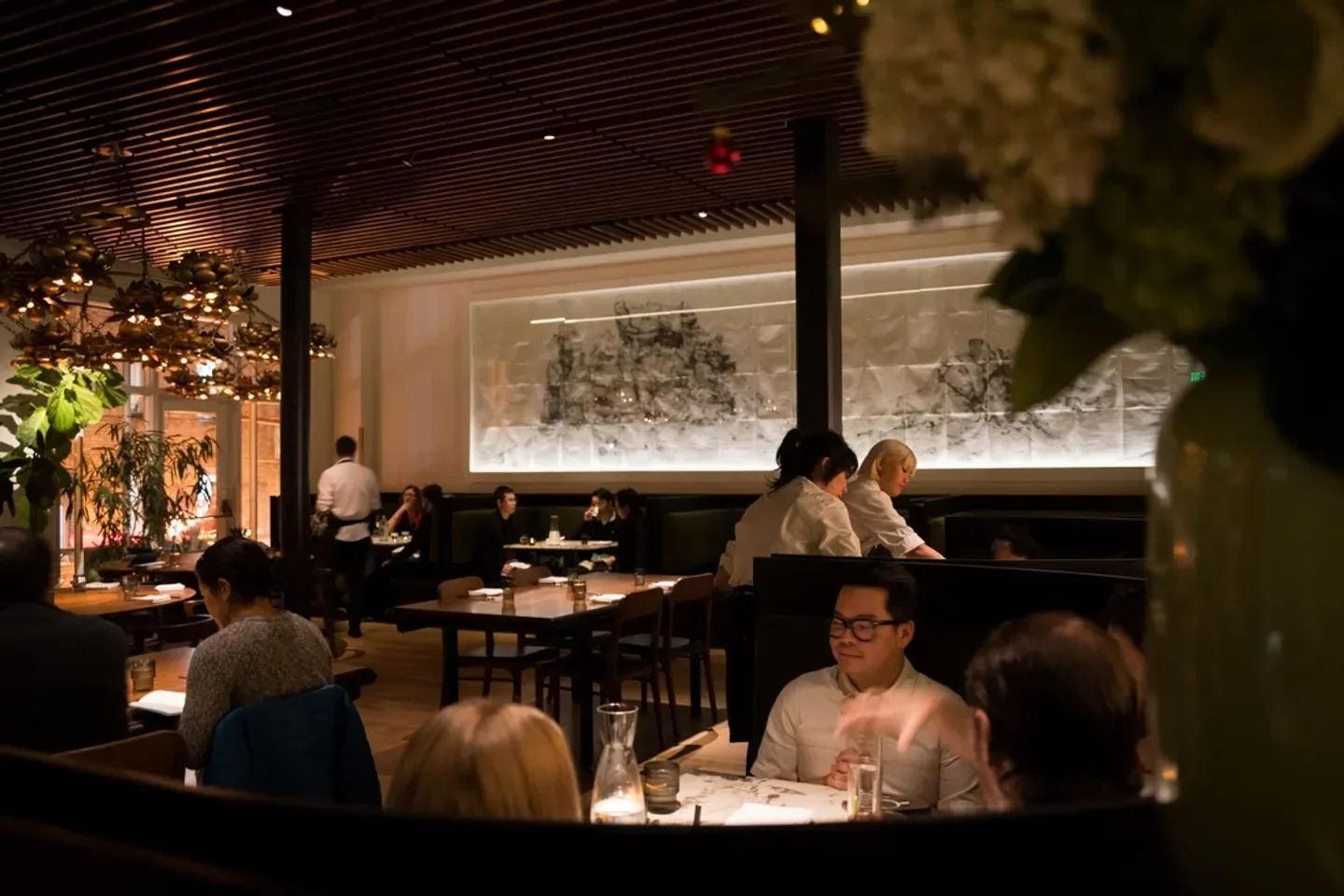 Interior dining at Mister Jiu's restaurant in San Francisco, with guests and decor