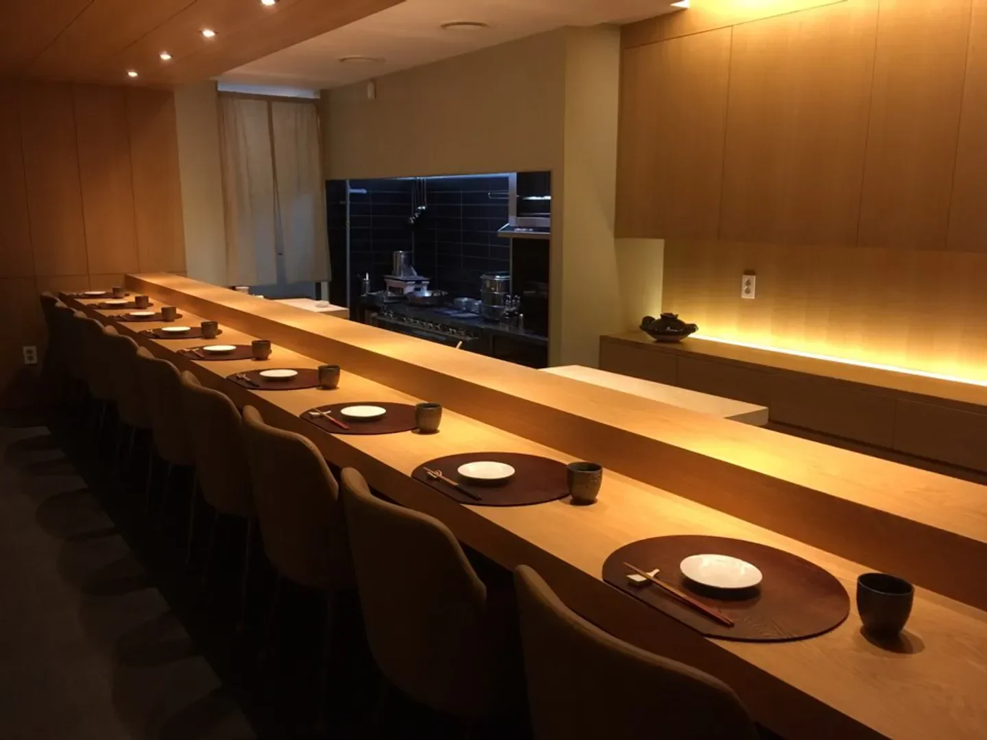 Interior of Mitou restaurant in Seoul, showcasing elegant wooden sushi bar setting.