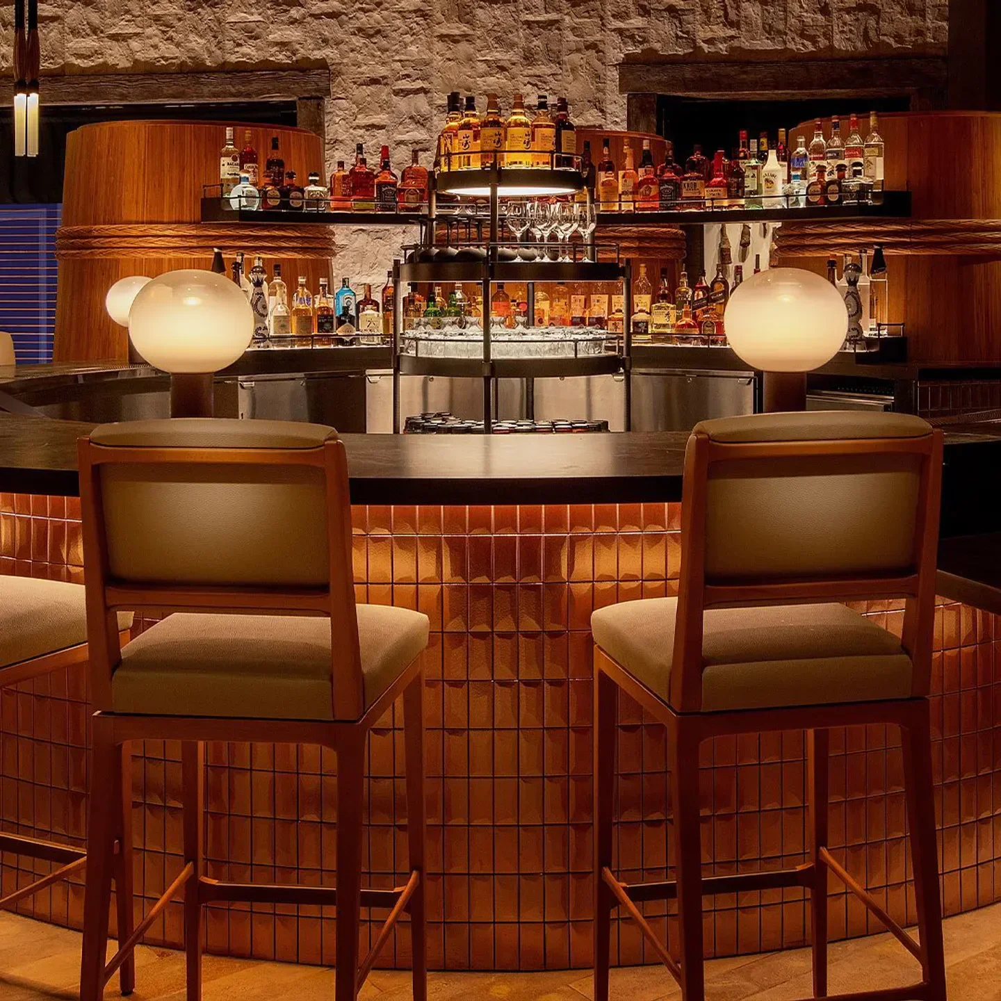 Interior bar at Mizumi in Las Vegas, featuring stylish seating and an impressive bottle display