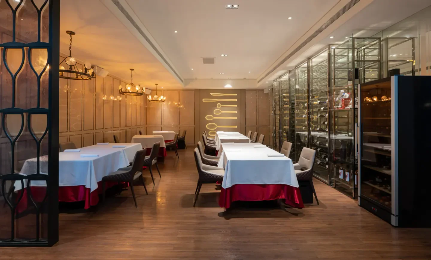 Interior of Molino de Urdániz restaurant in Taipei, featuring elegant dining tables and wine display.