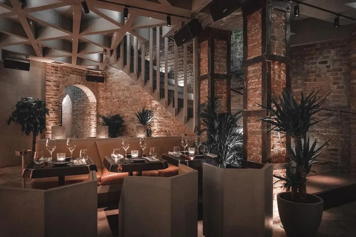 Cozy interior of Moloko restaurant in Paris with exposed brick and elegant tables.
