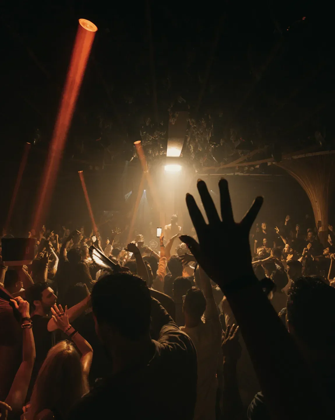 Energetic crowd partying under the lights at Momento nightclub in Marbella.