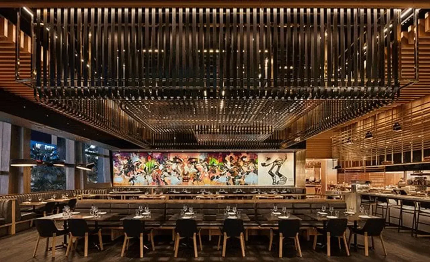 Interior of Momofuku Las Vegas, showcasing the restaurant's stylish design and artistic mural