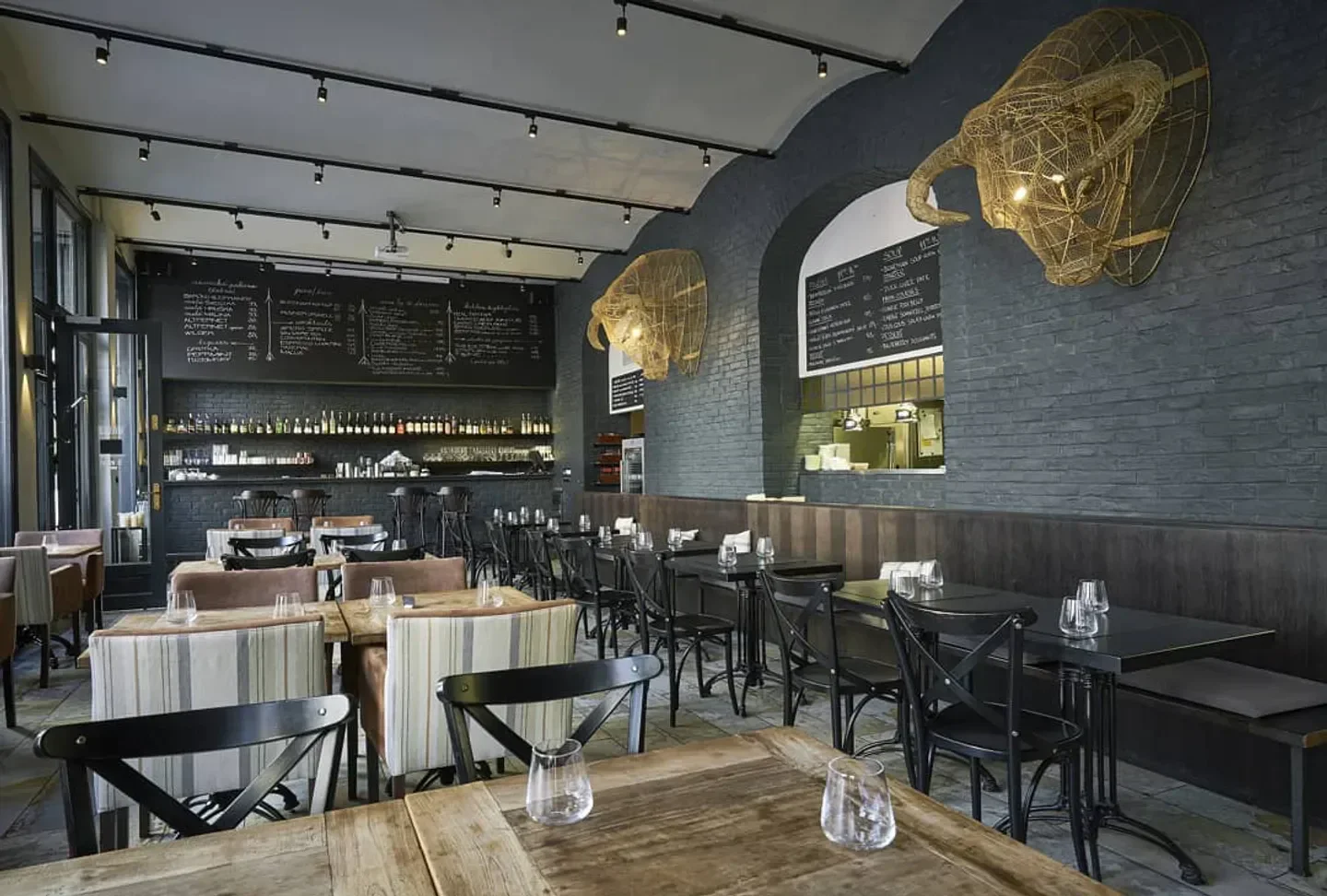 Interior dining space at Monarch restaurant in Prague with decorative bull head art.