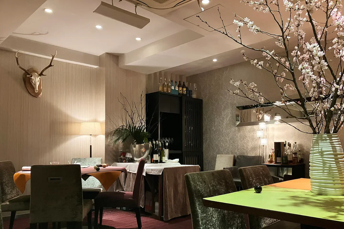 Cozy interior of MONOLITH restaurant in Tokyo, featuring elegant decor and floral arrangements.