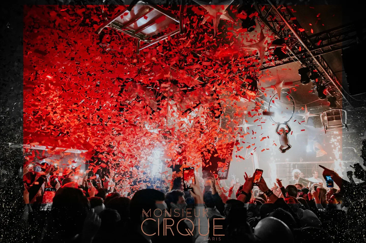 Confetti and excitement at Monsieur Cirque nightclub in Paris, with acrobatic performers.