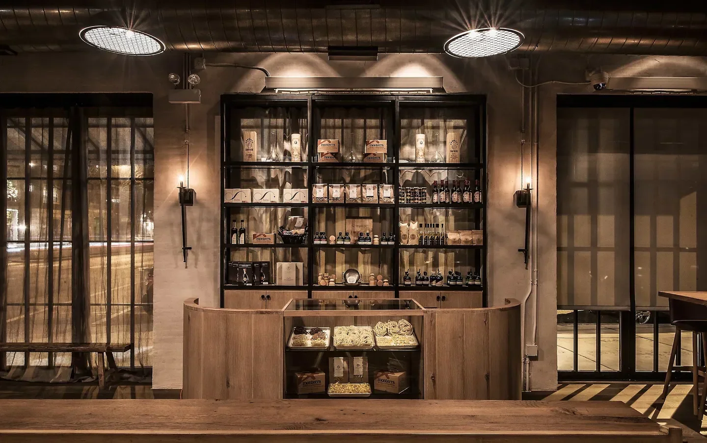 Interior of Monteverde restaurant in Chicago, with shelves and pasta on display.