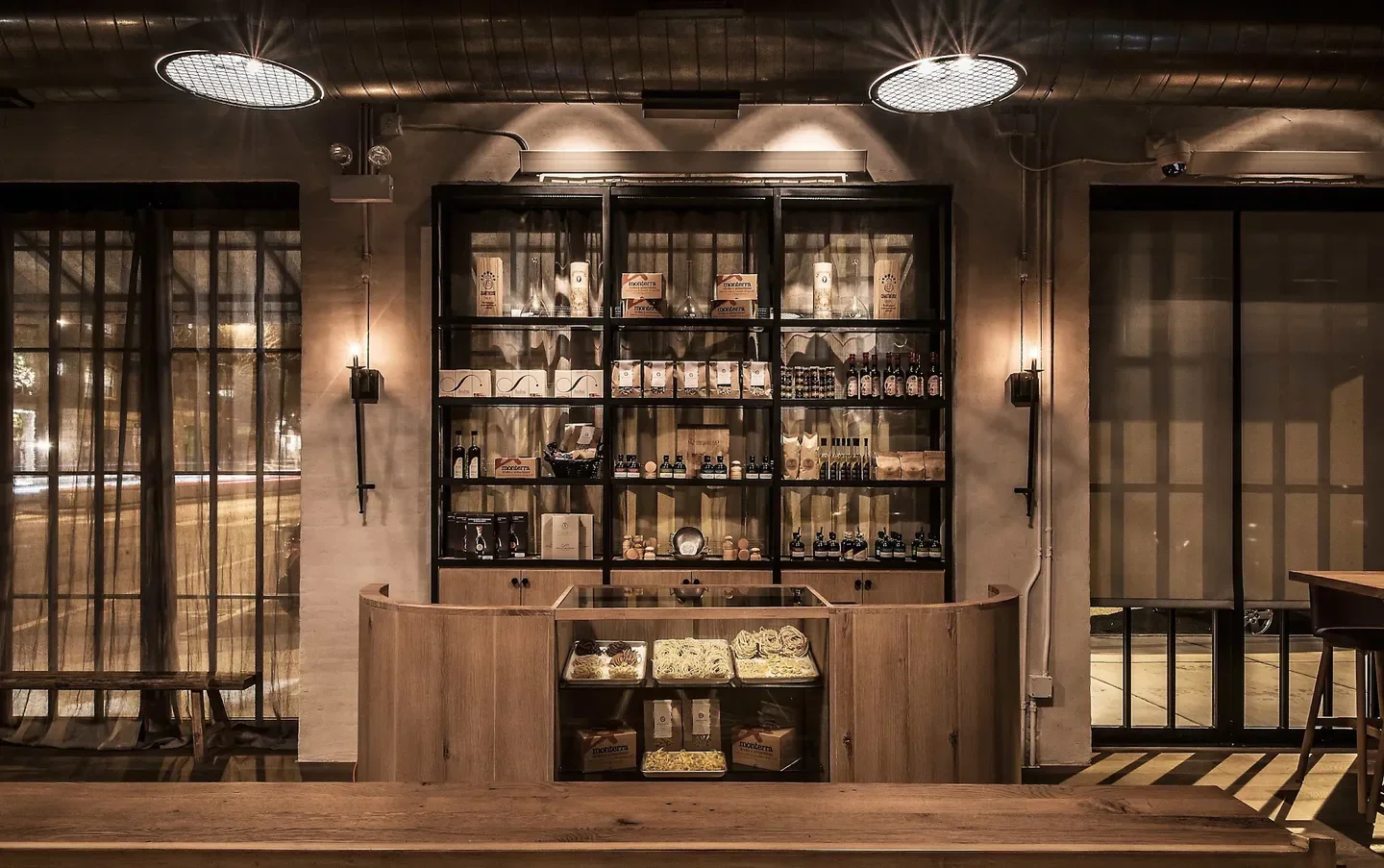 Interior of Monteverde restaurant in Chicago, with shelves and pasta on display.