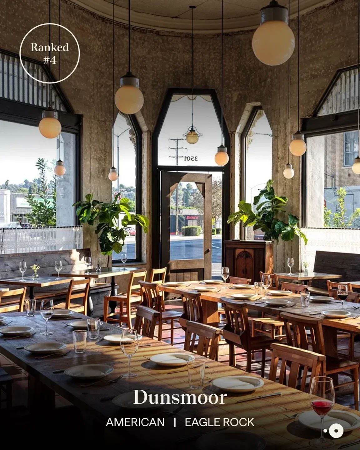 Interior of Morihiro restaurant in Los Angeles with wooden tables and elegant light fixtures.