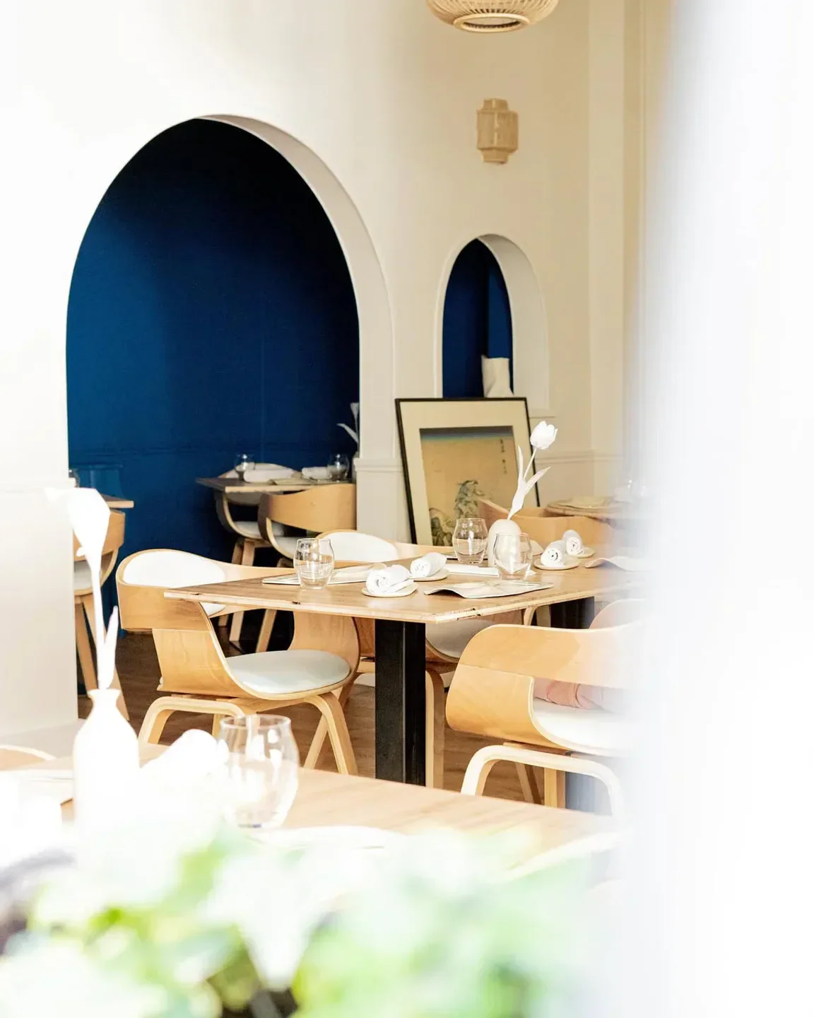 Interior view of MoSuke restaurant in Paris, featuring stylish wooden chairs and decor.