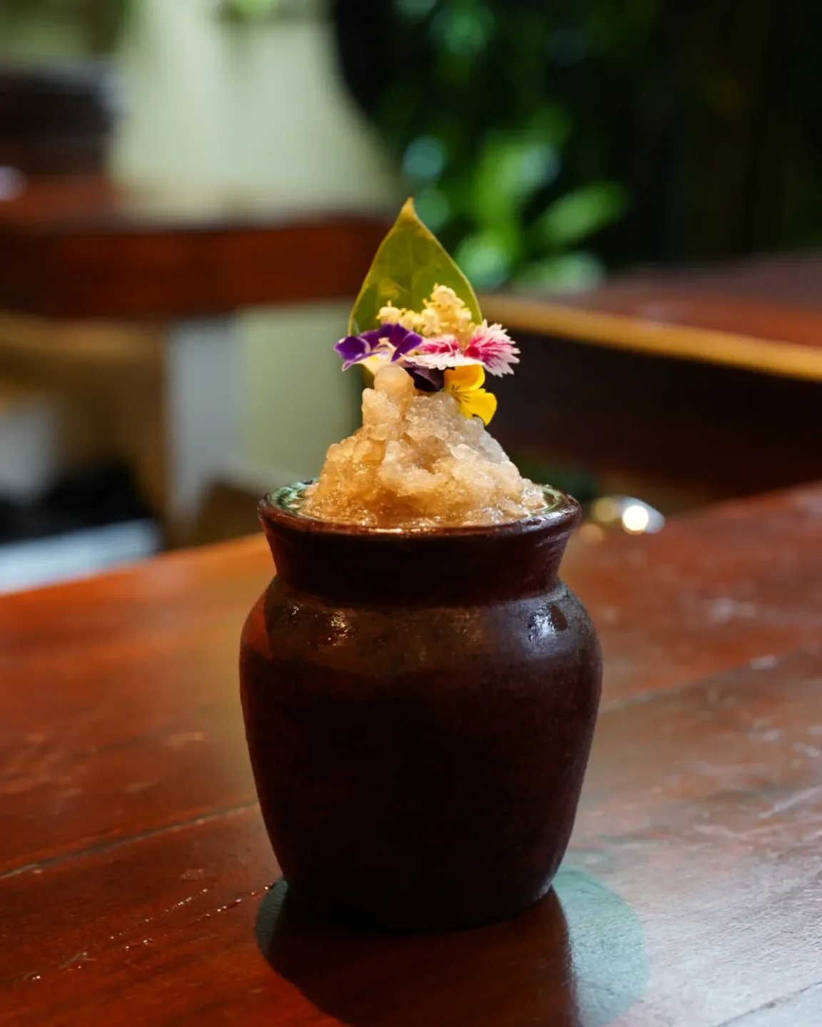 Mozaic restaurant in the city serves a beautifully garnished iced drink in a rustic pot