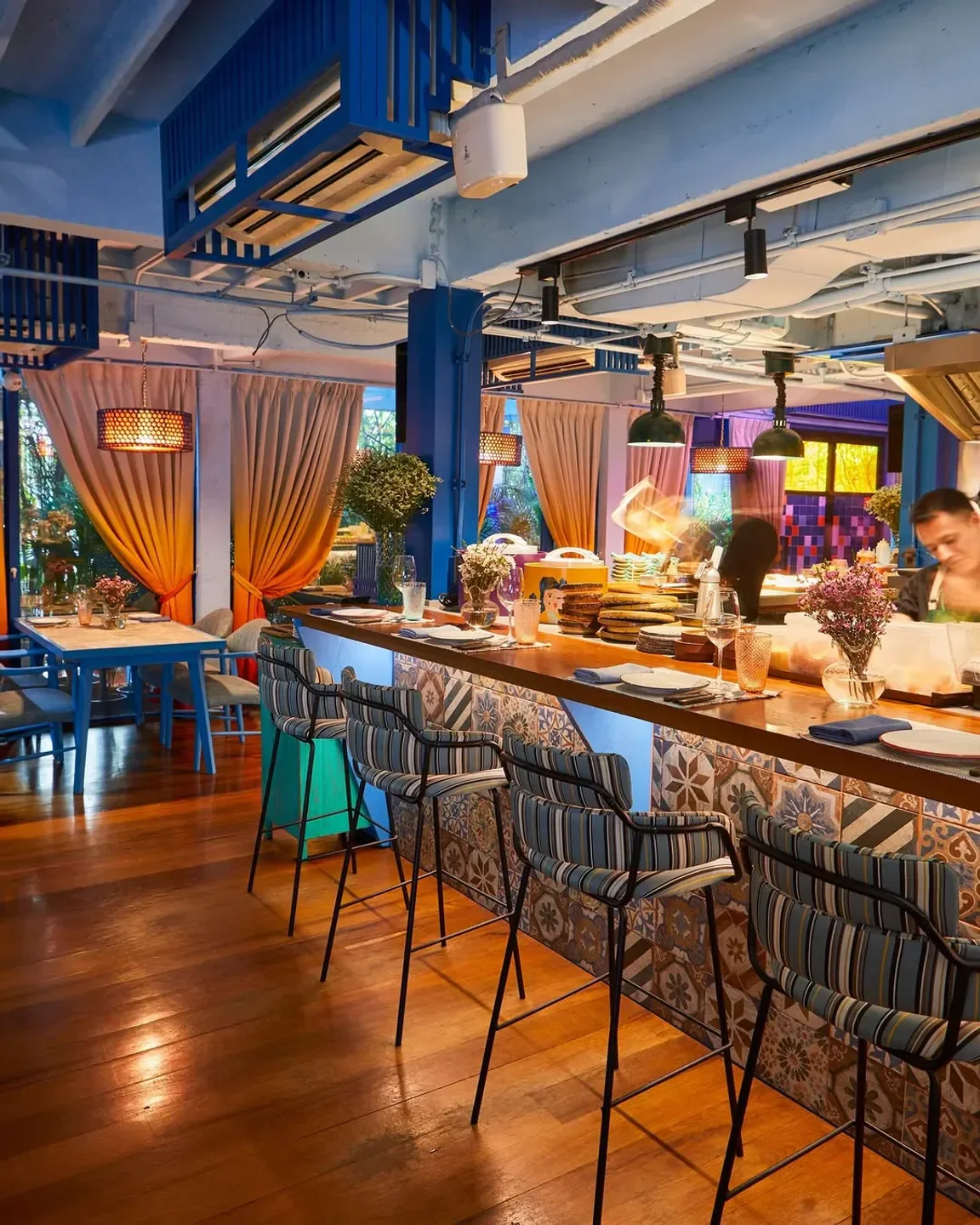 Interior of Ms. Maria & Mr. Singh restaurant in Bangkok, featuring a stylish bar area.