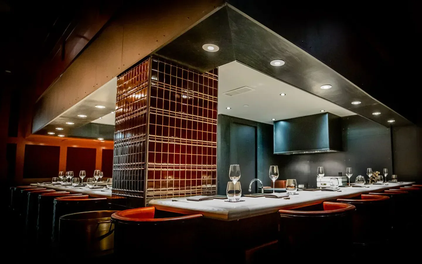 Interior view of the bar at Mujō, a restaurant in Atlanta, featuring elegant seating.
