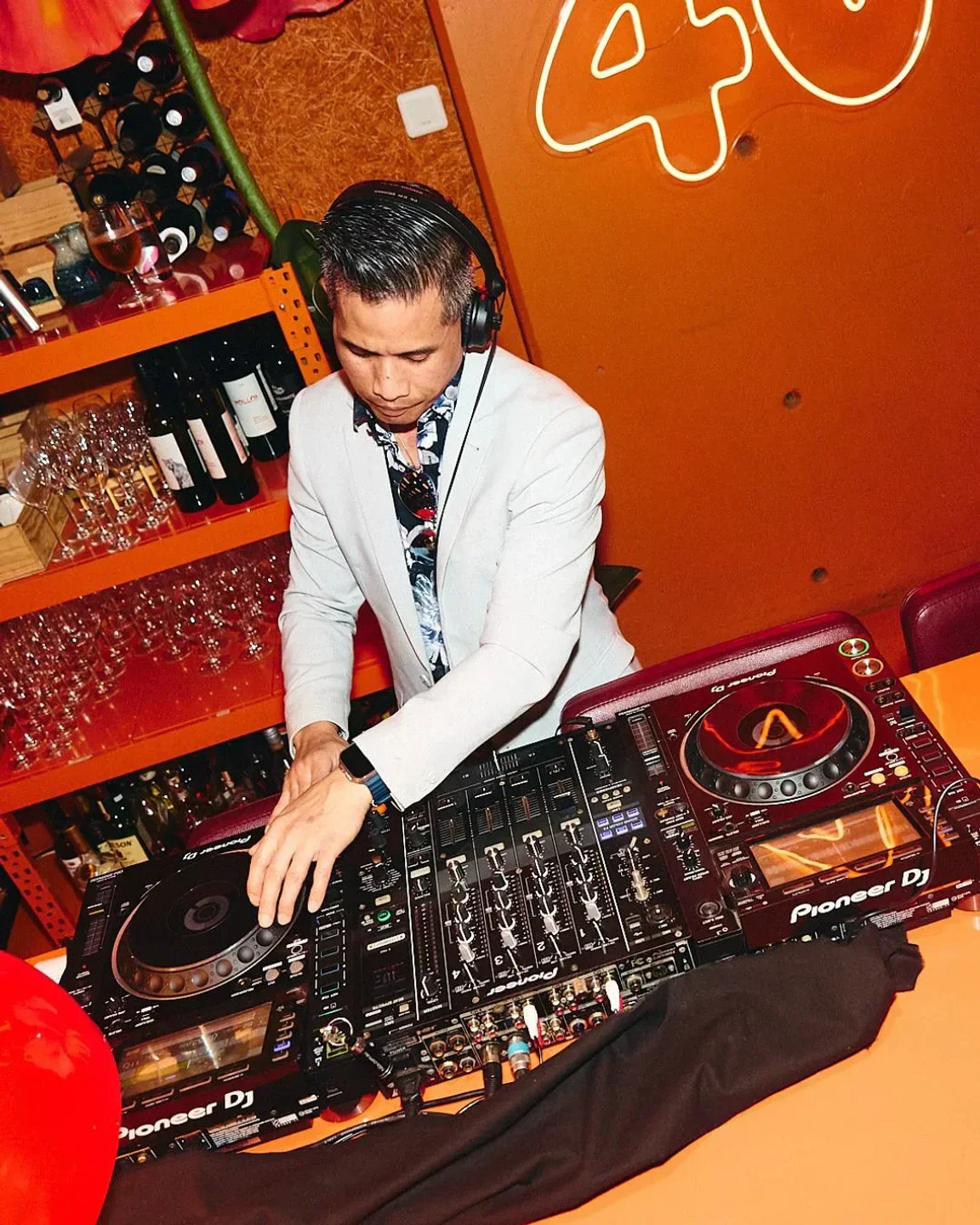 DJ at MuMu Sydney restaurant, mixing music with Pioneer DJ equipment.