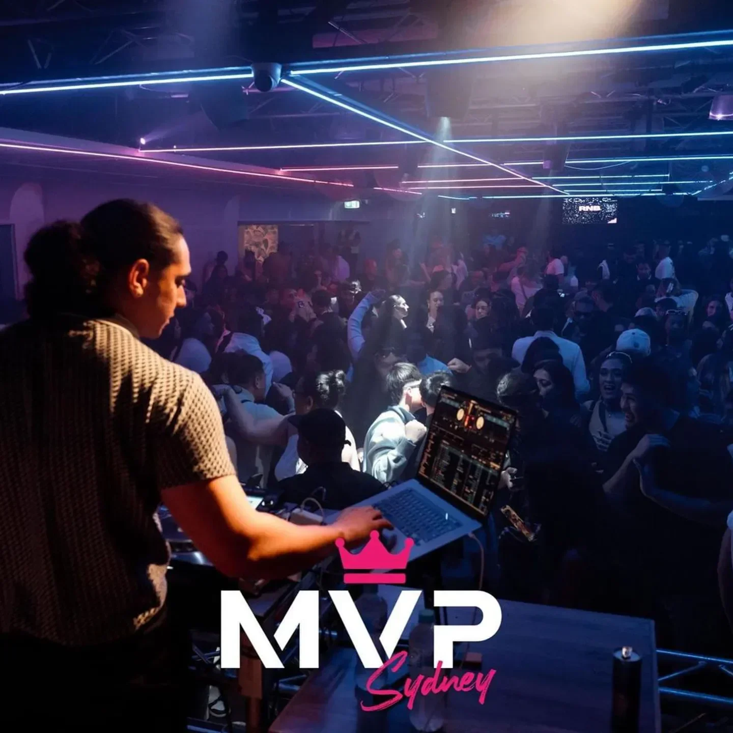 DJ at MVP Nightclub Sydney, playing music for a crowd of people in the venue.