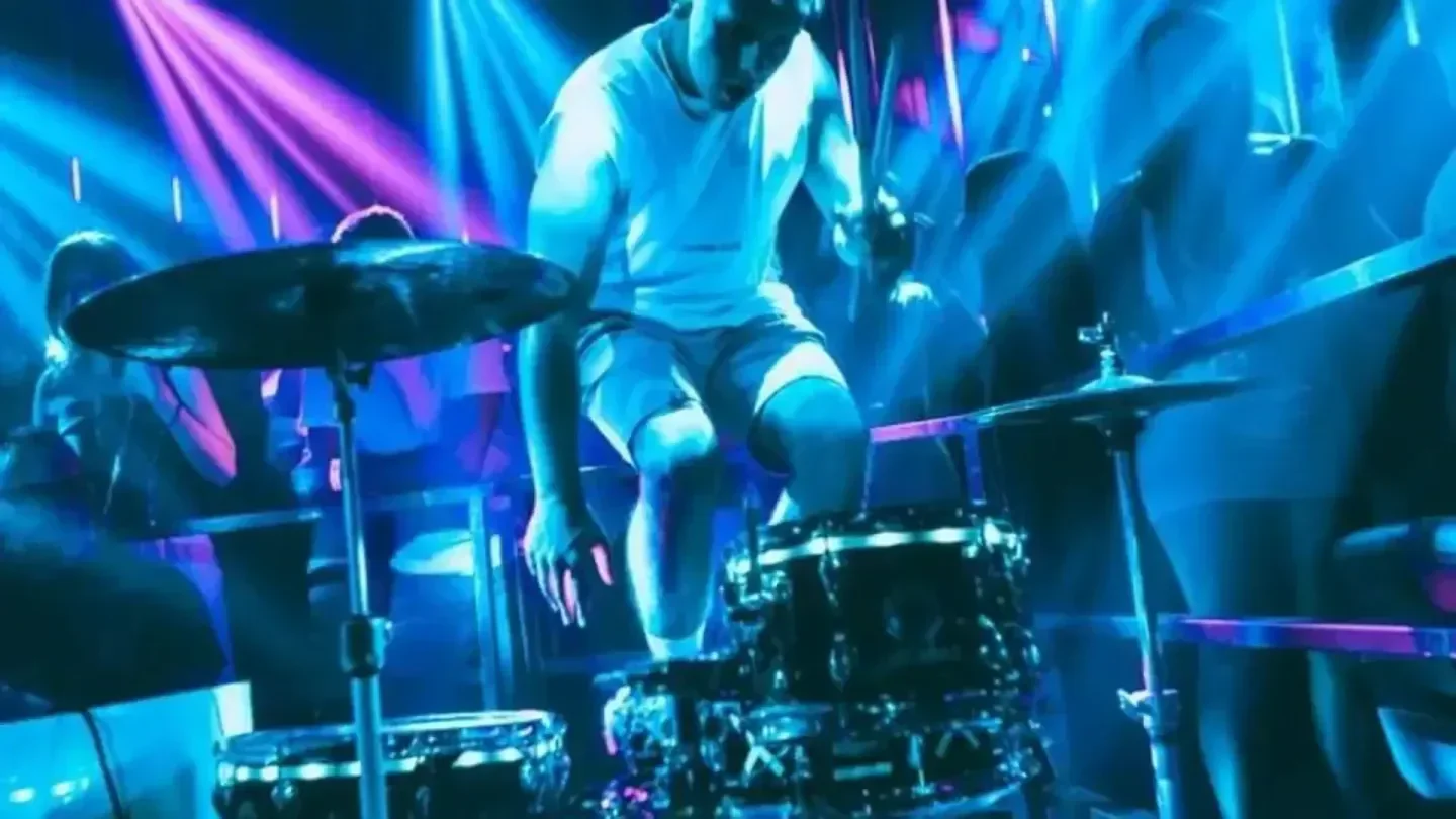Drummer playing at Mya Club Valencia under neon lights, creating a vibrant atmosphere.