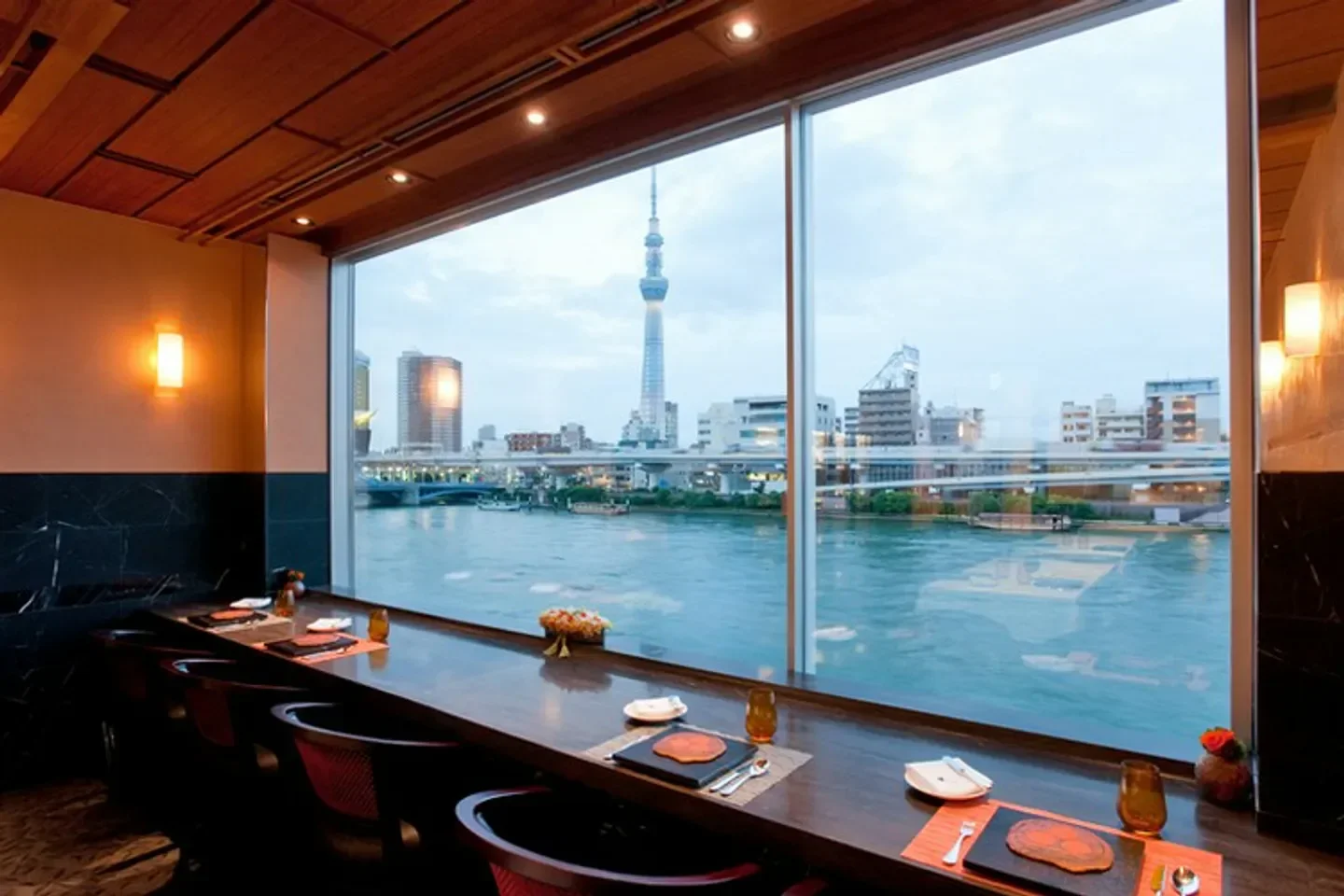 Restaurant Nabeno-Ism in Tokyo with views of the city skyline and Tokyo Skytree.