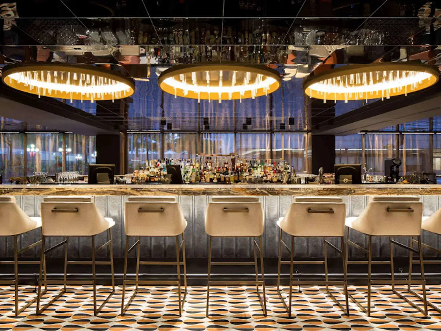 Interior of Nacarat in Montreal, featuring bar stools and stylish lighting.