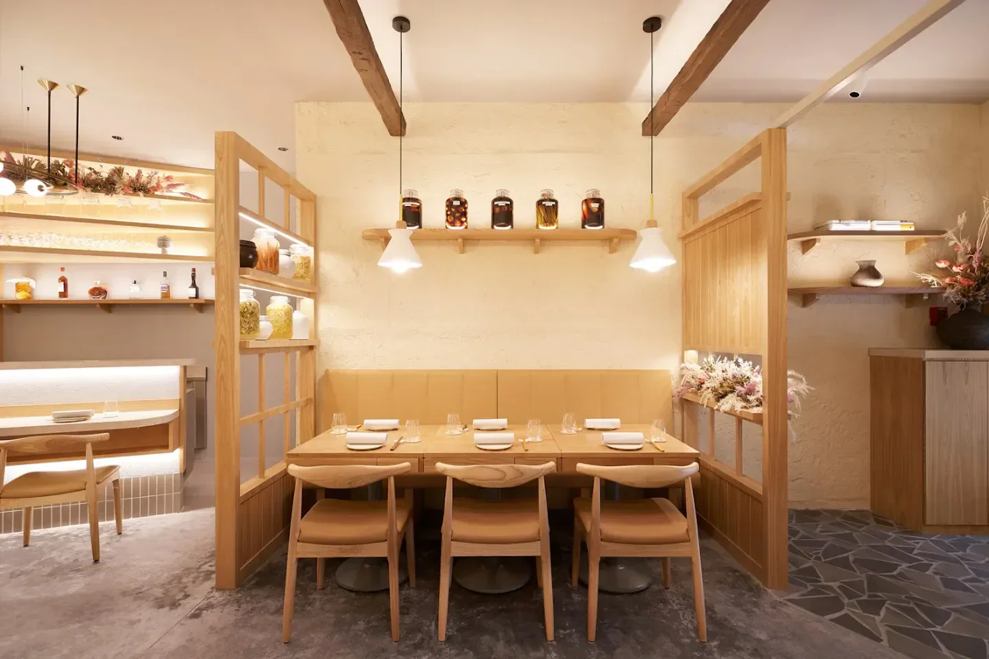 Cozy dining area at Nae:um restaurant in Singapore with elegant wooden furniture.