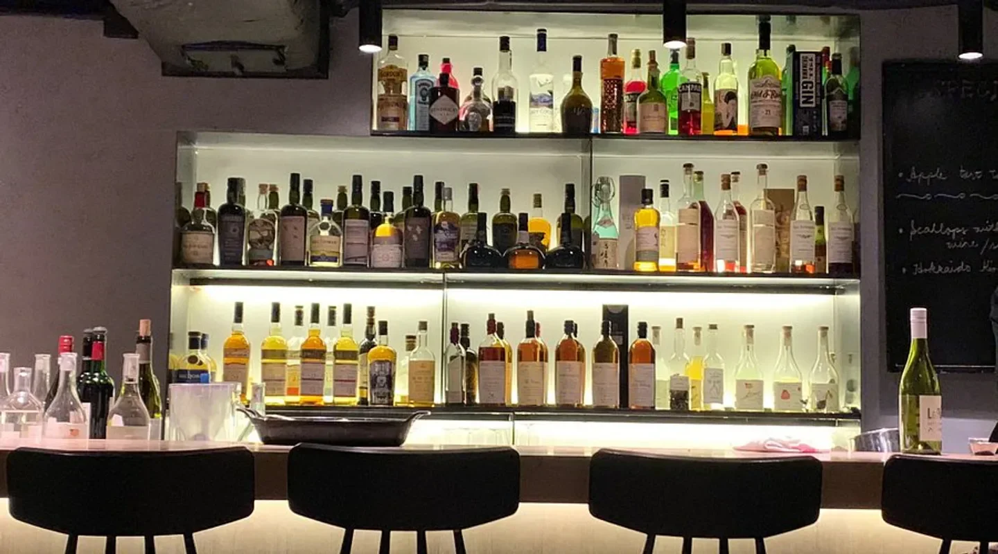 Well-stocked bar at Neighborhood in Hong Kong, showcasing an array of spirits and drinks.