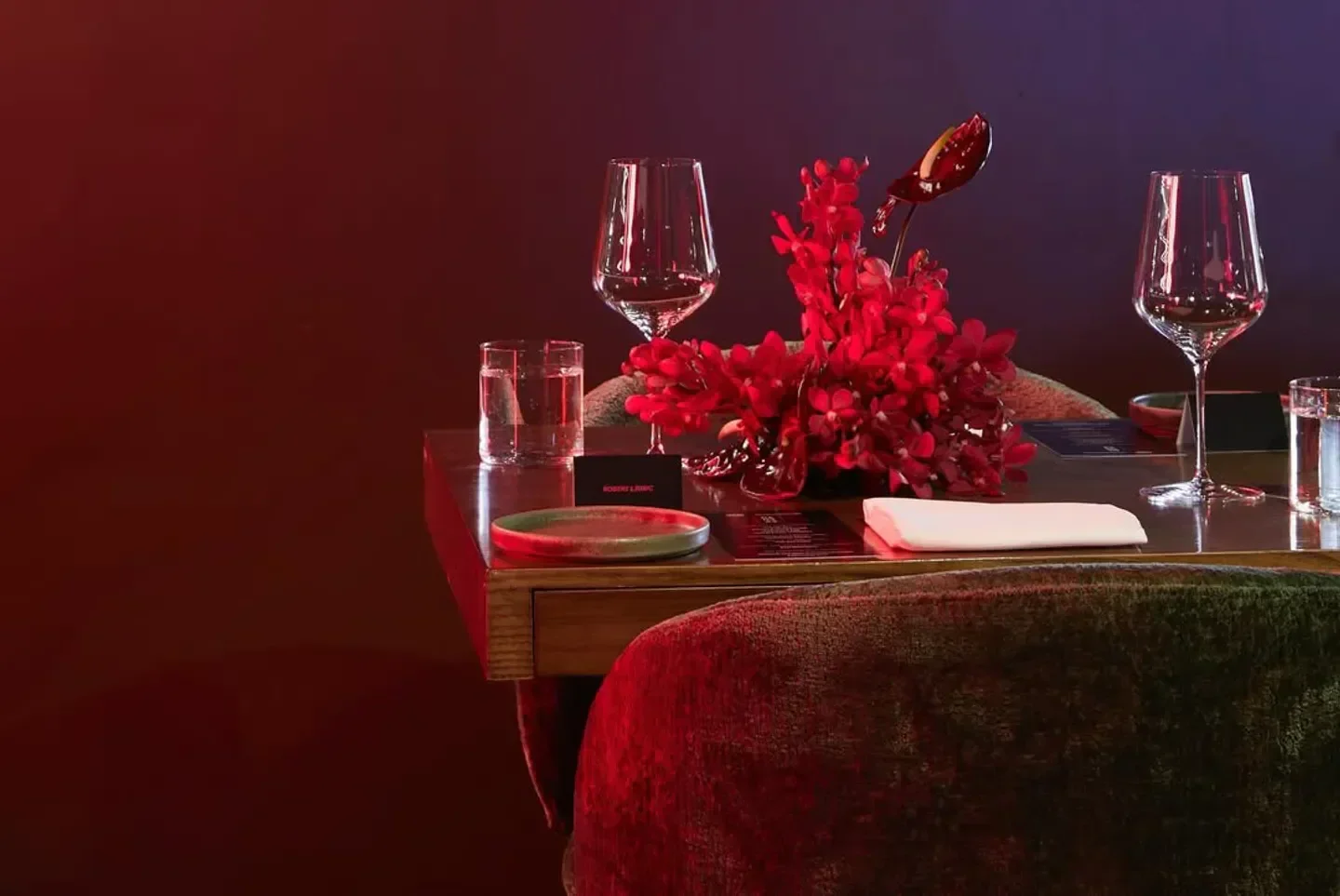 Elegant table setting at nel. Restaurant in Sydney with floral arrangement and wine glasses.
