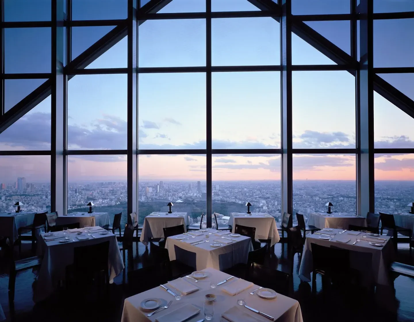 New York Grill in Tokyo with sunset view, elegant tables, and city skyline through windows