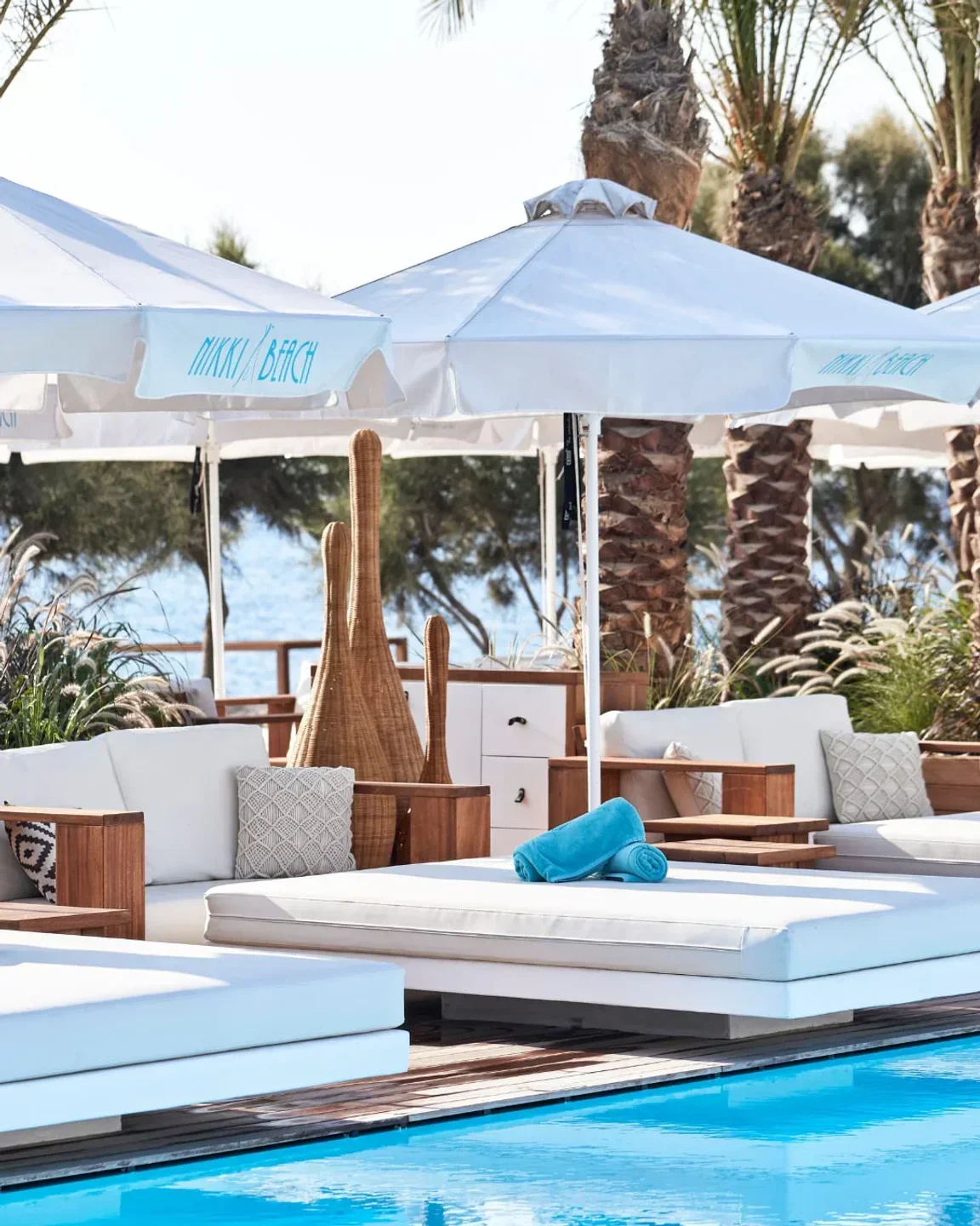 Nikki Beach Santorini: Luxury sunbeds, umbrellas, and pool at this stunning beach club