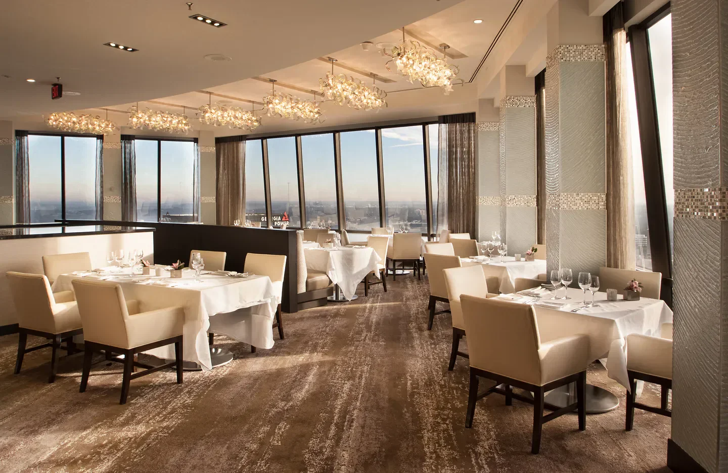 Elegant dining room interior at Nikolai's Roof restaurant in Atlanta with city views