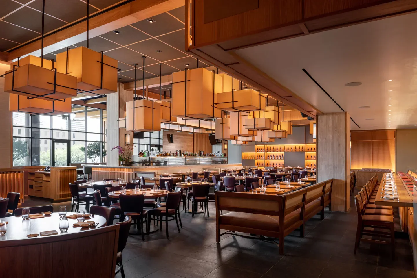 Elegant dining area inside Nobu Houston, featuring stylish lighting and inviting atmosphere.