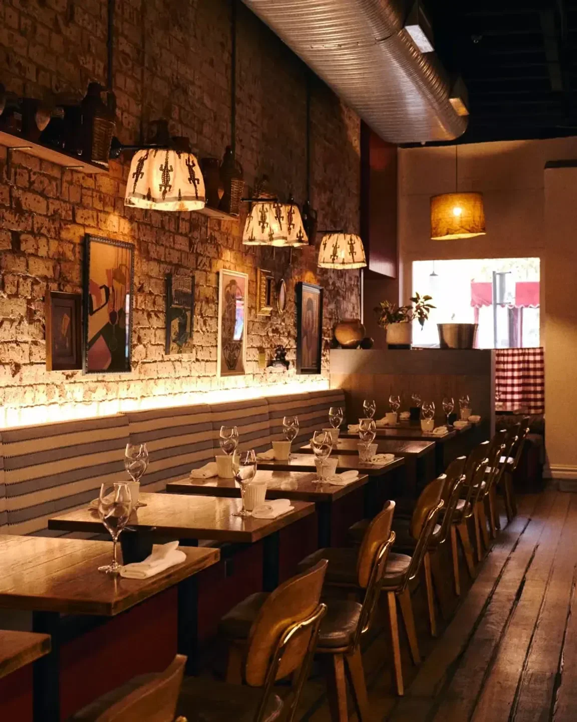 Cozy interior of Noi restaurant in Sydney, with warm lighting and rustic decor.