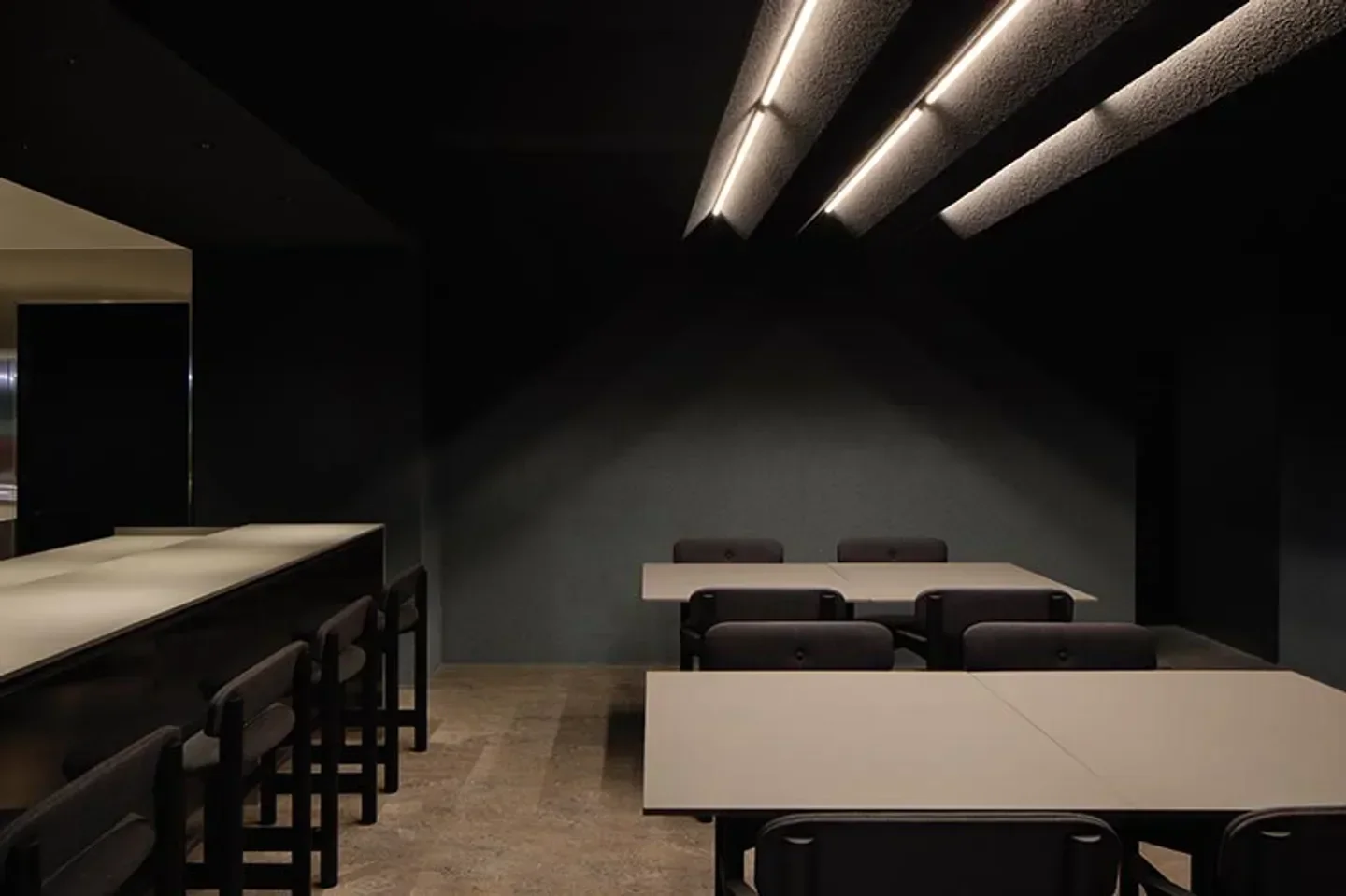 Minimalist interior of nôl restaurant in Tokyo, featuring tables and seating with modern design.