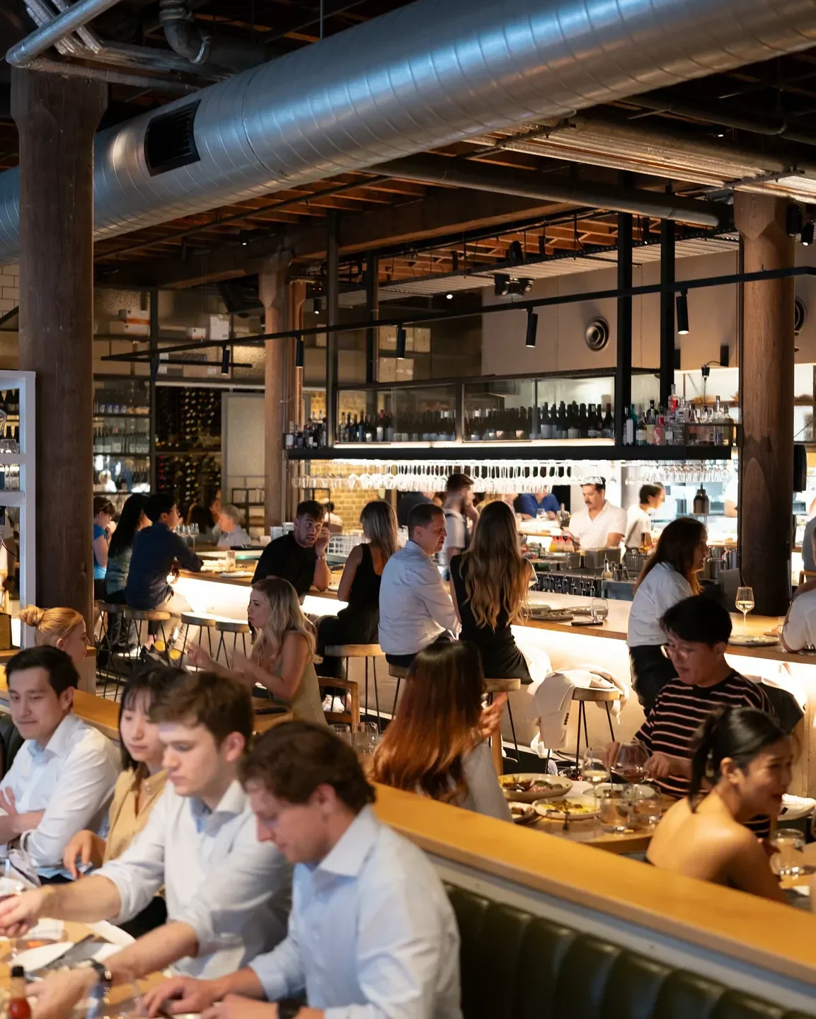 Dining scene at NoMad Sydney restaurant in Sydney, featuring bar and table seating.