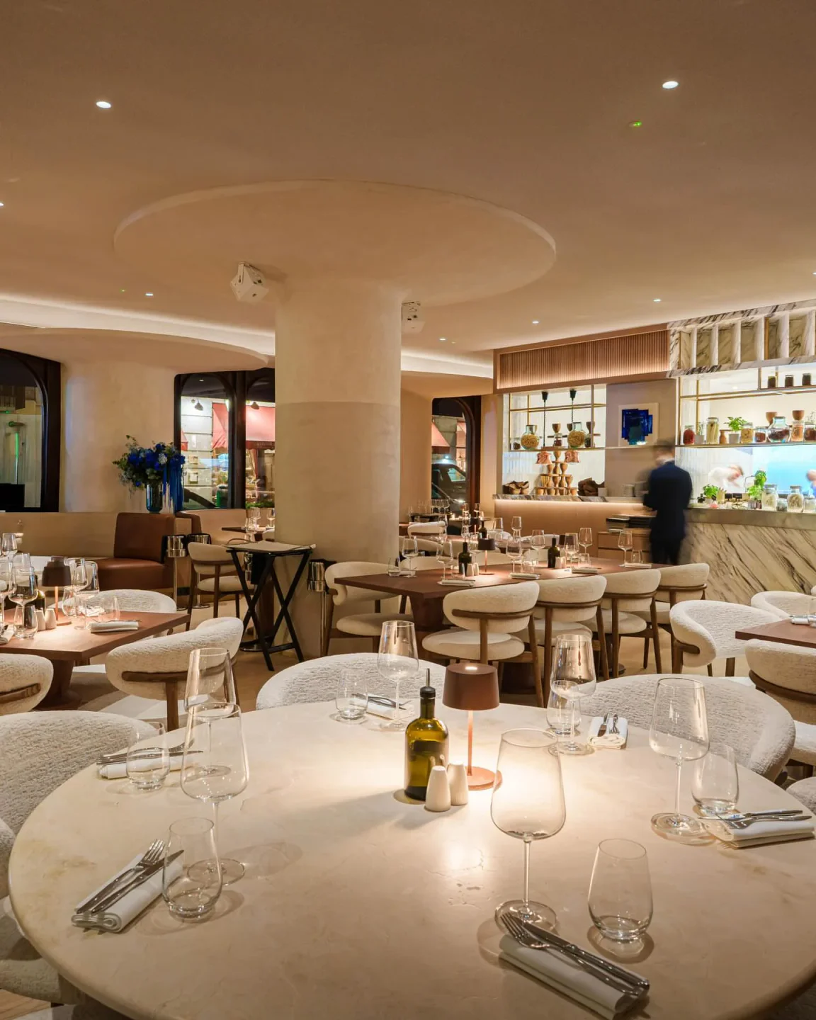 Stylish interior of Nota Blu New Brasserie restaurant featuring elegant dining tables and a chic bar area.