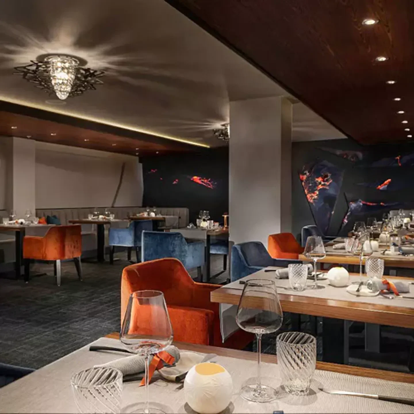 Elegant interior of O' by Claude Le Tohic restaurant in San Francisco, featuring colorful seating.