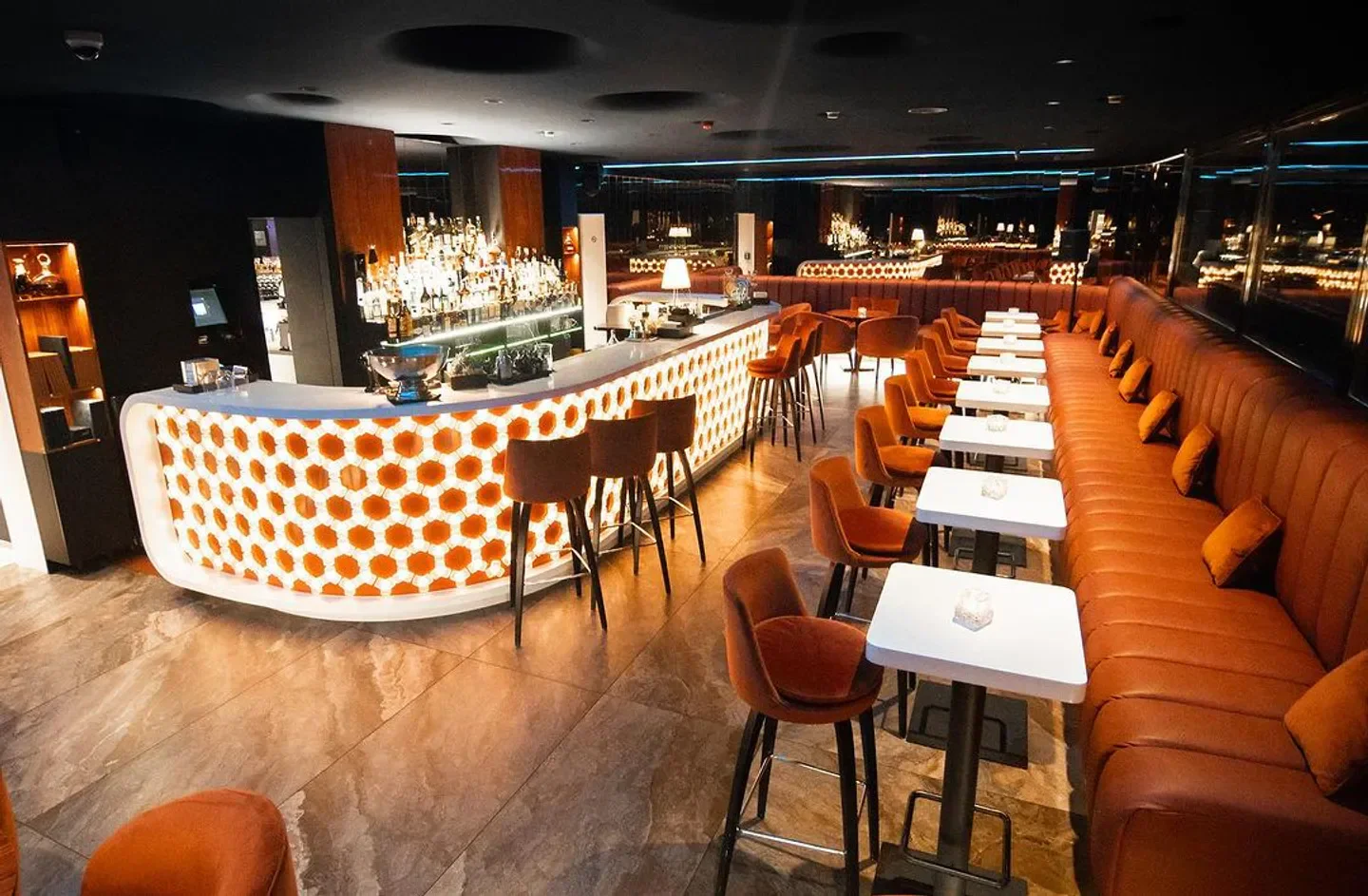 Stylish interior of Oblaca restaurant in Prague, featuring a bar and seating area.