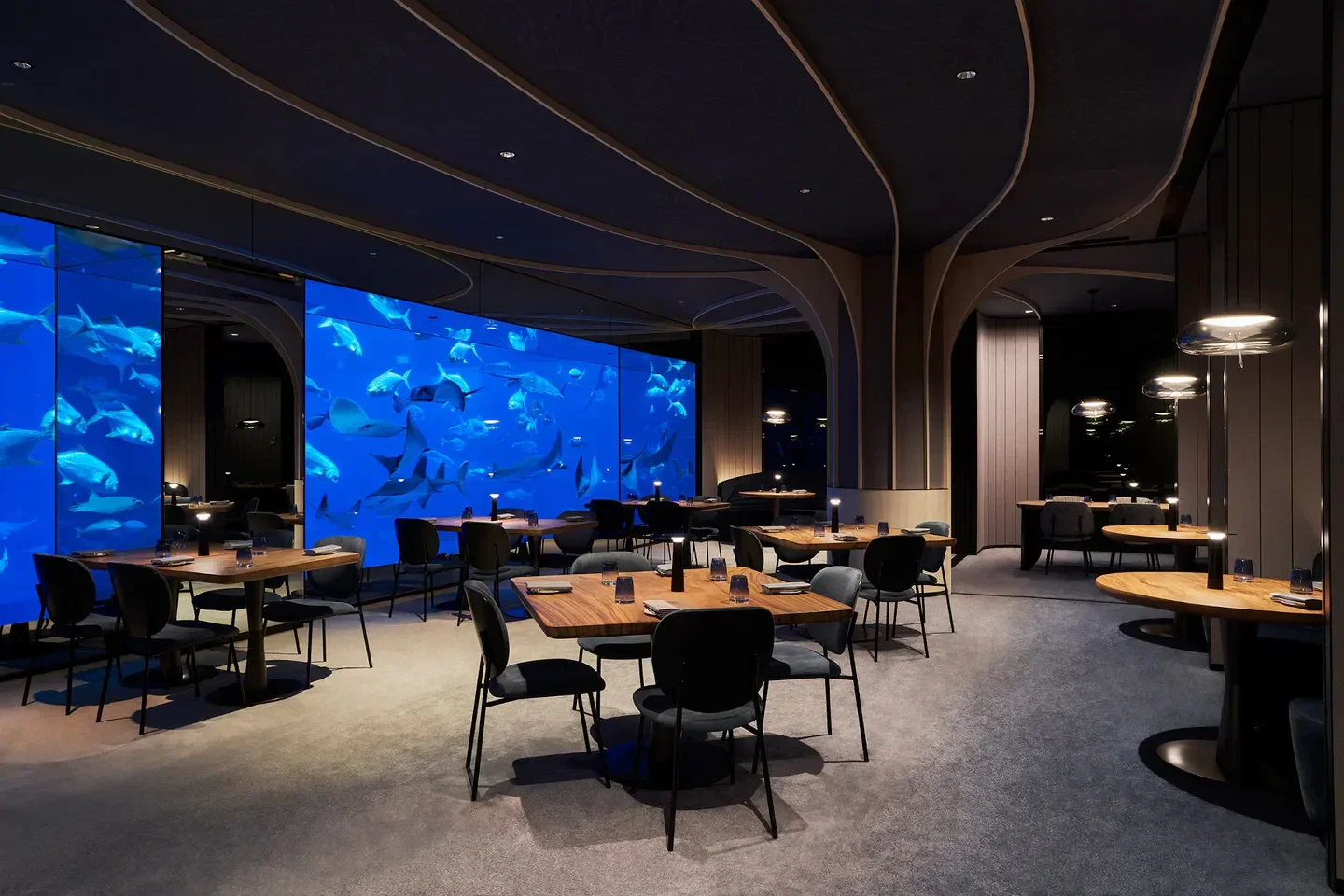 Interior of Ocean Restaurant in Singapore with aquarium and dining tables