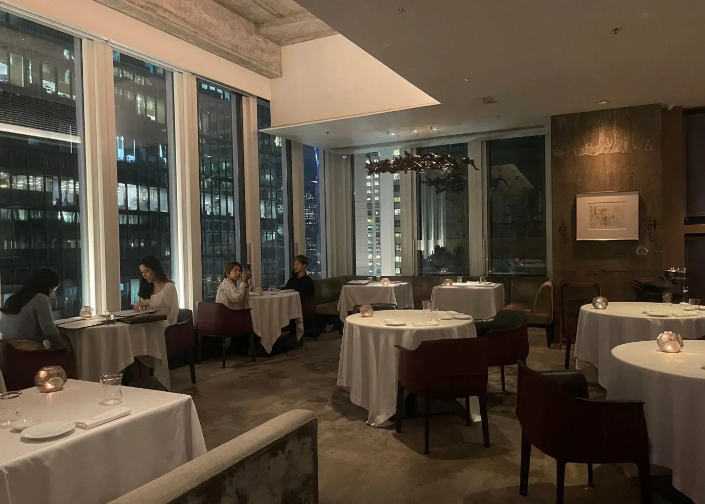 Dining room at Octavium restaurant in Hong Kong with city views at night