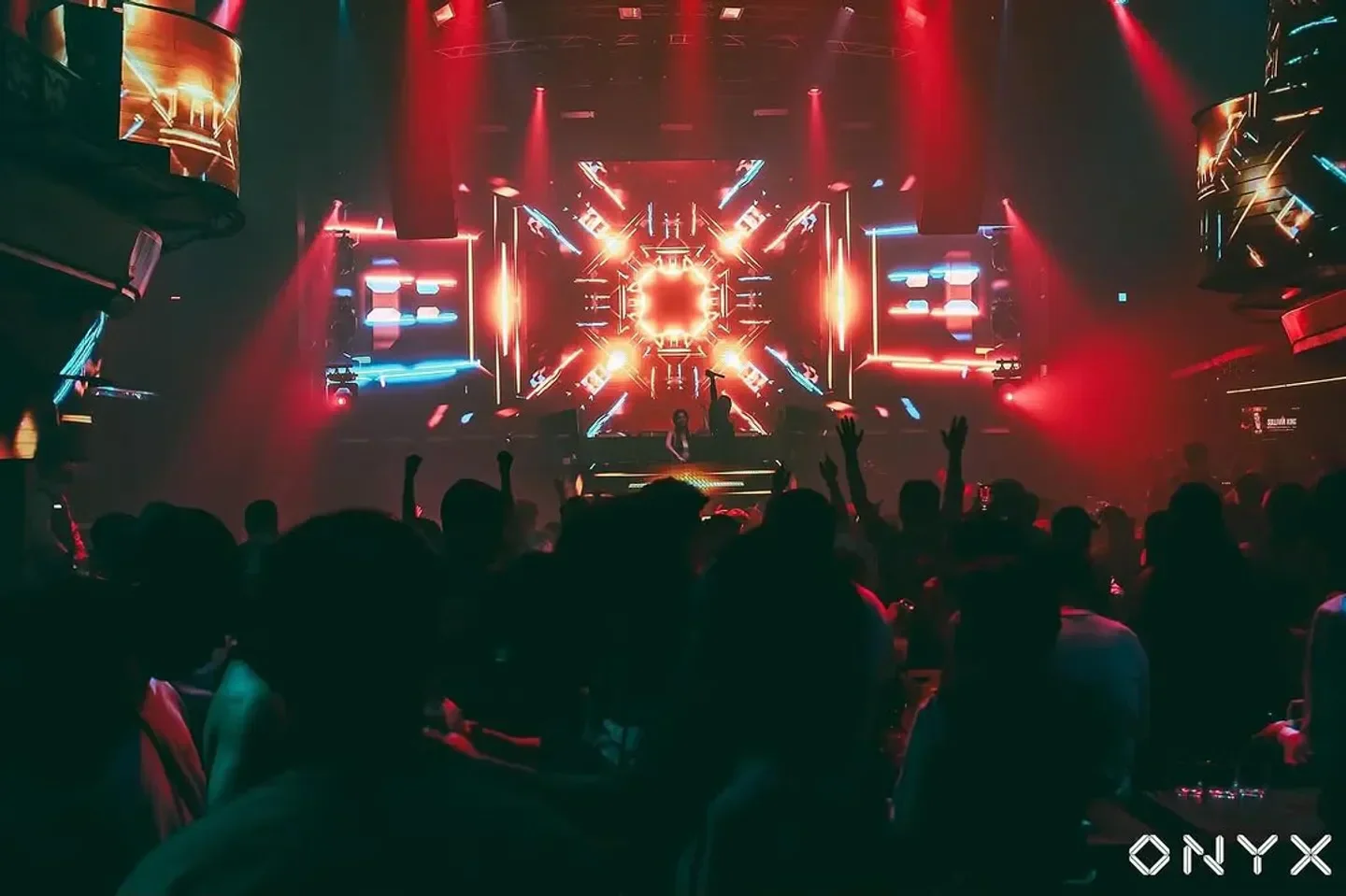 Energetic crowd at Onyx Bangkok nightclub enjoying the music and lights in Bangkok.