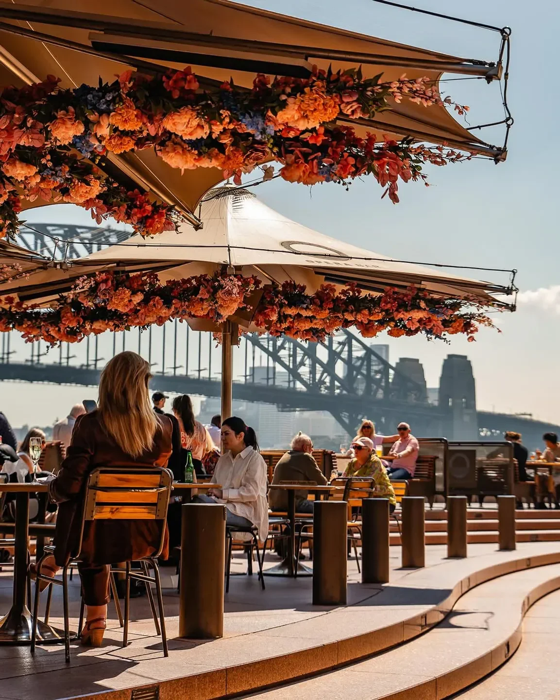 Opera Bar in Sydney with floral umbrellas, overlooking the harbor bridge.