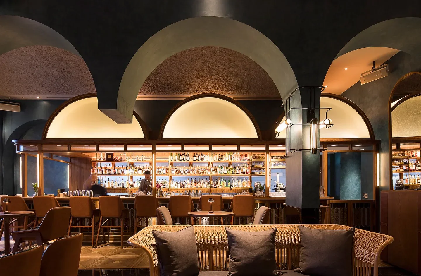 Elegant interior of Origin Bar & Grill in Singapore, featuring stylish bar and seating.