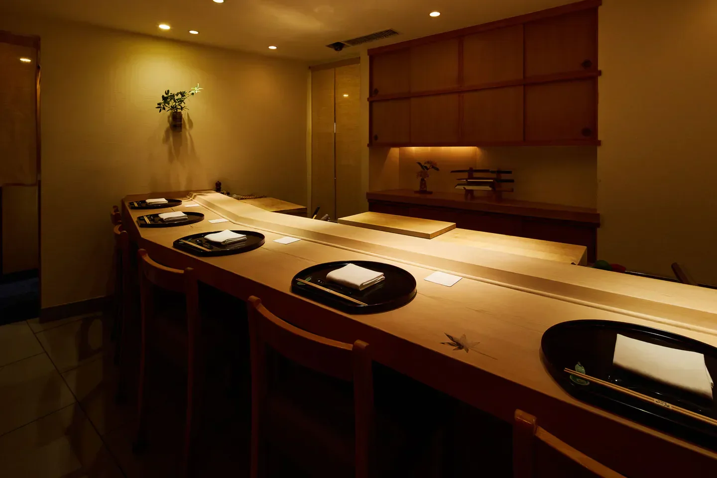 Interior of Oryori Katsushi restaurant in Tokyo, featuring a minimalist sushi counter and decor.