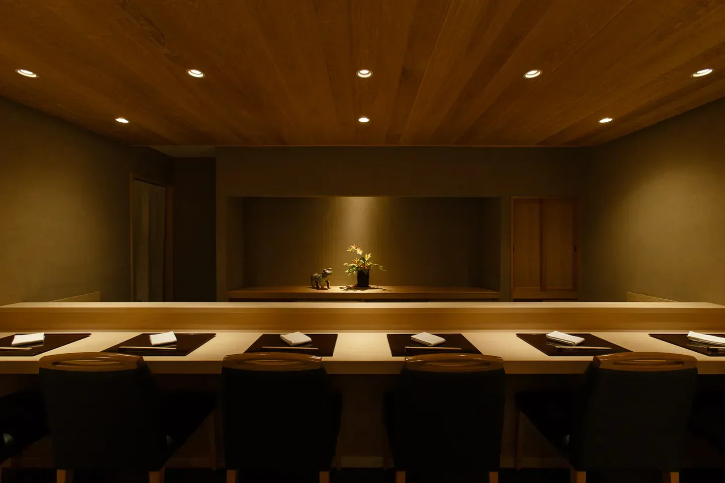 Interior of Oryori Tsuji in Tokyo, with seating, wooden accents, and decorative elements.