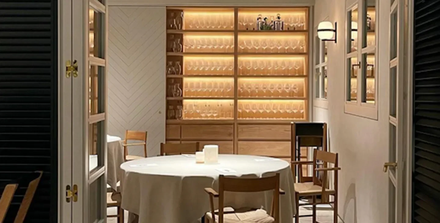 Cozy dining room at OSA Madrid restaurant, featuring a table setting and elegant decor.