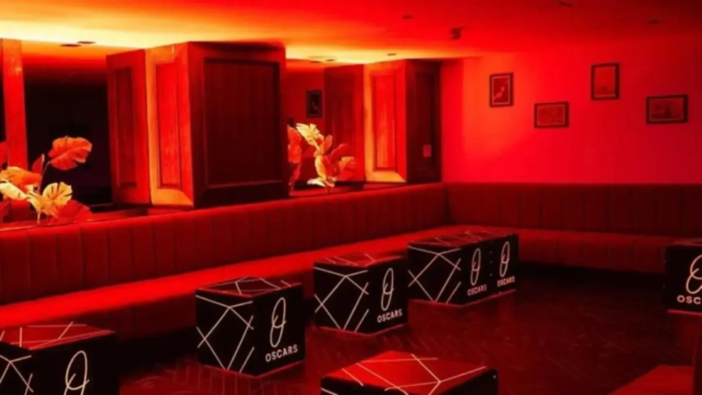 Stylish interior of Oscars Mayfair nightclub in London with red lighting and unique decor.