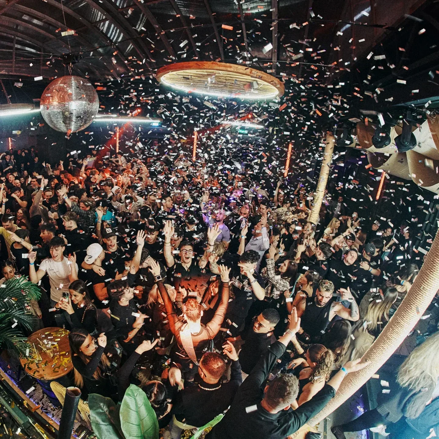 Energetic party at Ötkert nightclub in Budapest, celebrating with confetti and a lively crowd.