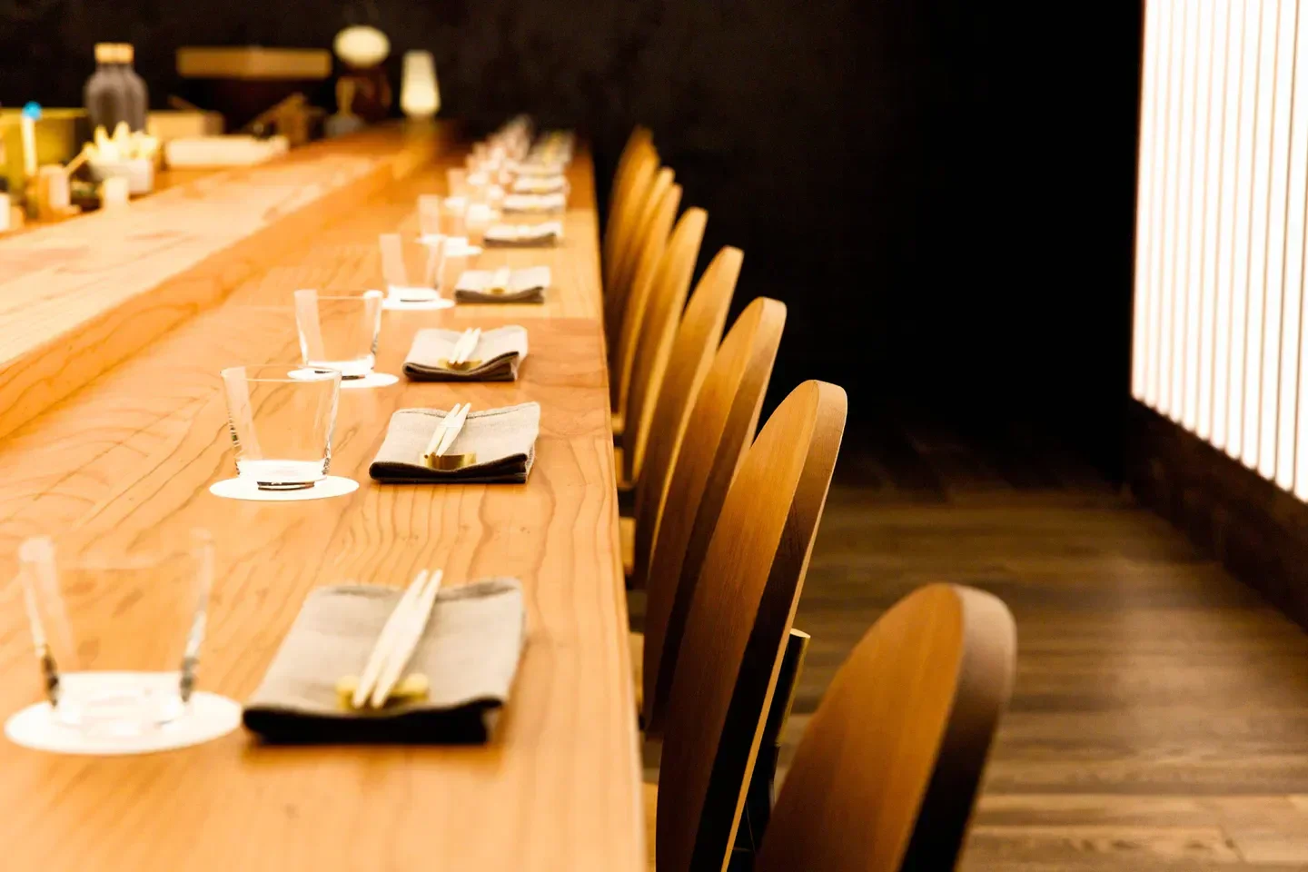 OTOKO in Austin: Stylish restaurant interior with wooden chairs and a long bar.