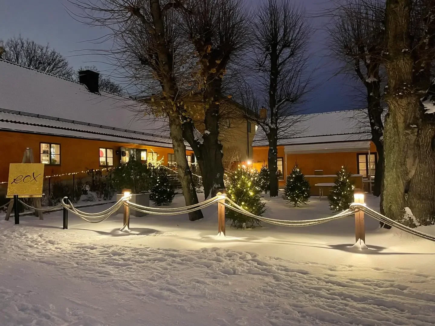 Winter scene at Oxenstiernan restaurant in Stockholm, with snow and festive lights.