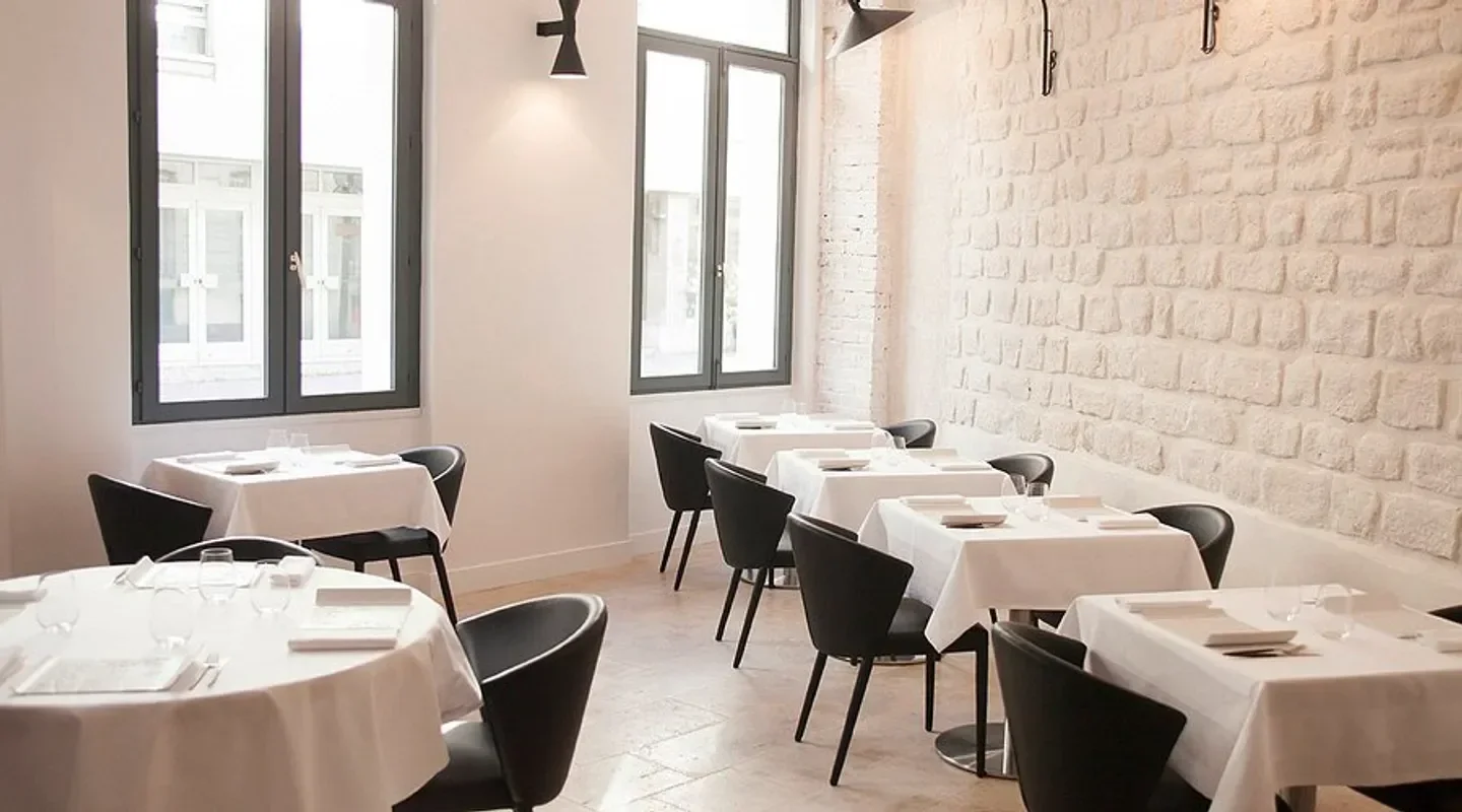Interior dining space at Pages restaurant in Paris with tables and chairs.