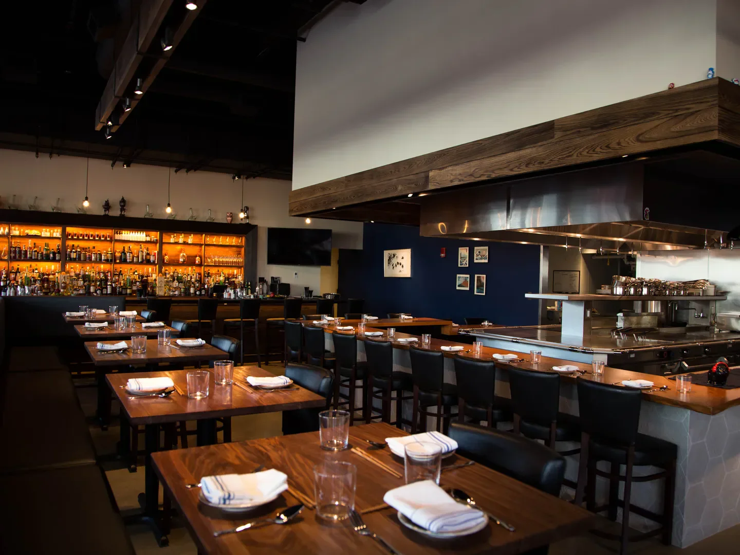 Interior view of PAGU restaurant in Boston featuring bar and dining area.