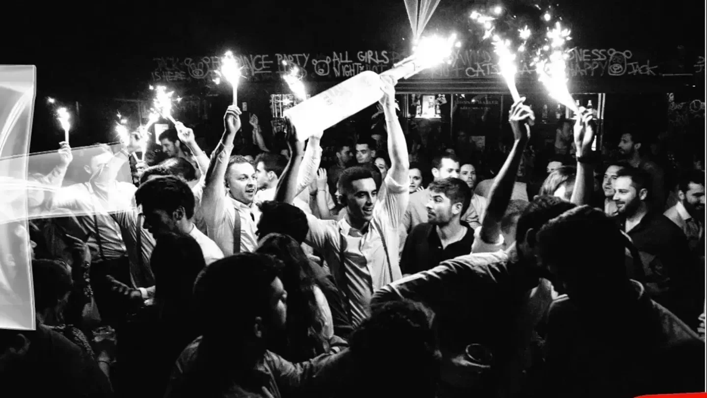 Party at Panda Club in Madrid with bottle sparklers and a lively crowd.